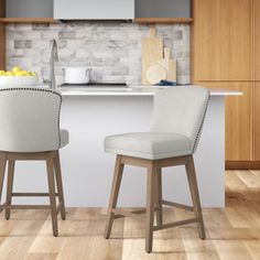 two chairs sitting in front of a counter top with lemons on the table next to it