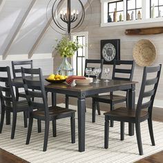 a dining room table with six chairs