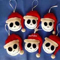 six skull ornaments with santa hats on them