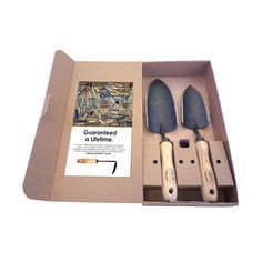 three knives in a cardboard box on a white background