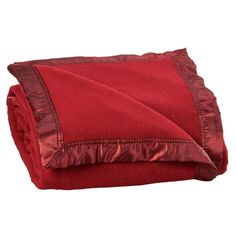 a red blanket folded on top of a white background