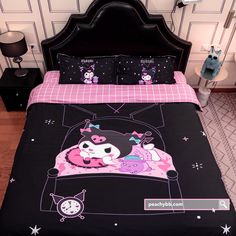 a black bed with pink and white designs on it