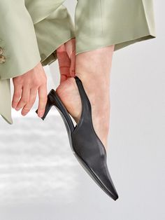 - Pointed toe- Wave upper line- Slingback strap- Mid heelMeasurements- Heel: 1.9in- Size: KR225(US5.5)-255(US8.5)- This item is based on the KR shoe size. Please refer to the size chart.Composition- Upper: Sheepskin- Lining: Synthetic LeatherDesigner- Made in Korea- by MEIEL DEW- Style#: 300923418 Evening Slingback Kitten Heels With Heel Loop, Evening Slingback Pumps With Low Heel And Heel Loop, Sleek Slingback Kitten Heels With Padded Heel, Black Slingback Kitten Heels With Wrapped Heel, Fitted Slingback Pumps With Heel Loop And Pointed Toe, Fitted Pointed Toe Slingback Pumps, Sleek Open Toe Slingback Pumps With Sculpted Heel, Formal Slingback Kitten Heels With Heel Loop, Sleek Pointed Toe Kitten Heels With Heel Loop