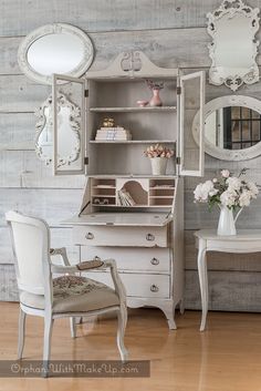 an antique white desk and chair in a room