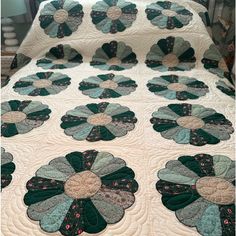 a quilted bedspread with flowers on it