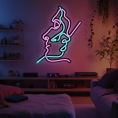 a neon sign in the shape of a man's face on a wall next to a couch