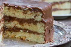 two slices of cake on a plate with one slice cut out and the other half eaten