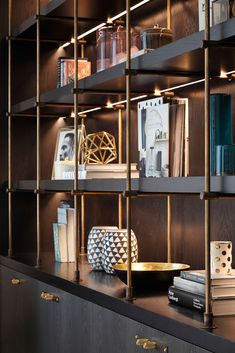 a book shelf filled with lots of books and other items on top of wooden shelves