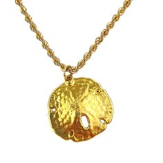 This vintage gold sand dollar pendant necklace exudes a charming beach-inspired aesthetic. The sand dollar charm adds a touch of nautical elegance, enhancing the boho chic vibe. Perfect for those who appreciate unique and timeless accessories, this necklace features an 18-inch rope chain that complements the gold pendant beautifully. * Vintage gold sand dollar pendant * 18-inch rope chain * Beach-inspired, nautical design * Boho chic style * Timeless and unique accessory N/A Size: 18", 1" pendant Gold Coastal Necklace For Vacation, Coastal Style Gold Necklace For Vacation, Ocean-inspired Gold Necklaces For Vacation, Gold Coastal Shell Necklace For Vacation, Gold Strand Necklace Ocean-inspired, Gold Strand Necklace With Ocean-inspired Style, Gold Strand Shell Necklace In Coastal Style, Gold Ocean-inspired Strand Necklace, Ocean-inspired Gold Strand Necklace