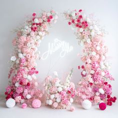 pink and white flowers are arranged around the word'happy'in front of it