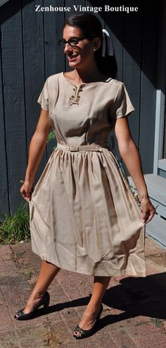 Hey Hipster Chick - this is the perfect unworn dress for you! Has the size tag still on it! So many lovely details to this item, pleats, Bust Darts, pretty bow at the neck, special buttons, and a nice belt.   Never worn, new with tag. Brand new 1950's...this is a rare find! Color: Bronze / Very light brown Material: Rayon Label:  Vintage Size: 14 - remember that vintage sizes were different than modern sizing!  Front: Please double for front and back armpit to armpit - 18" waist - 15" Bust - 16" with darts Shoulder to Waist - 17 Collar to waist: 14 1/2" Nice Belt, Nice Belts, Color Bronze, Rayon Dress, Find Color, Nice Shorts, 1950s Vintage, Dress Clothes For Women, Vintage 1950s