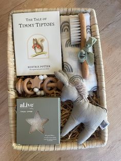 a basket filled with toys and books on top of a wooden floor