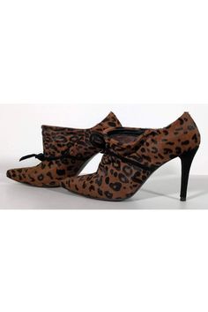 These fabulous booties are perfect to add a daring touch to any look. Made in an edgy animal print pony hair upper with stylish pointed toes. A black suede heel adds a contrasting look to the shoes. Size 6 M Pony hair upper Leather lining Pointed toe Suede covered heels Bows on front Come w/ dust bag Wear on pony hair on back of shoes Wear on suede on heels Some wear on sole Heel height 3.5" Brown Pointed Toe Heels For Winter, High Heel Leopard Print Heels For Fall, Leopard Print High Heel Boots For Party, Fall Leopard Print High Heel Shoes, Leopard Print Boots For Fall Party, Leopard Print High Heels For Fall, Leopard Print Winter Party Boots, Leopard Print Party Boots For Winter, Fall Leopard Print High Heels