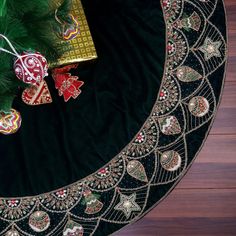 a christmas tree skirt with ornaments on it