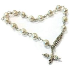 This pearl bracelet created by Jewelry By Carmal is made of: white freshwater pearls, sterling silver: dove charm, spring ring clasp and findings. This bracelet measures 7 1/2 inches in length. View more beaded bracelets: http://www.etsy.com/shop/jewelrybycarmal?section_id=8002918 Pearl is the birthstone for June and the gemstone for the 3rd and 30th Wedding Anniversaries. All of our jewelry arrives wrapped and ready for gift giving! We offer free standard shipping (via USPS) within the United S Wedding Rosary Bracelet With Pearl Charm, Elegant Silver Pearl Bracelet For First Communion, Elegant Pearl Bracelet For First Communion, Elegant Pearl Jewelry For Confirmation, White Pearl Charm Bracelet For First Communion, Elegant Pearl Bracelet With Pearl Charm For First Communion, Pearl Bracelet For First Communion, White Pearl Bracelet For First Communion, Pearl White Bracelet For First Communion