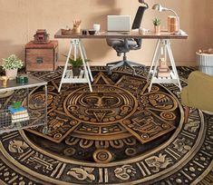 a computer desk sitting on top of a floor covered in an area rug that looks like a sundial