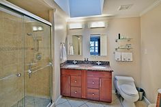 a bathroom with a sink, toilet and shower