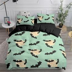 a bed with green and black sheets has bats on it