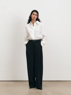 This Over Fit Shirt exemplifies modern minimalism with its oversized silhouette and crisp tailoring. The structured collar and clean button placket provide a timeless look, while the relaxed fit adds a contemporary edge. It's an ideal choice for those who favor a sophisticated yet unfussy aesthetic in their wardrobe. - The Over Fit Shirt is made from a breathable fabric, perfect for all-day comfort.- Its generous cut ensures ease of movement and a laid-back vibe.- The shirt's long sleeves and buttoned cuffs can be styled rolled up or down to suit different looks.- This versatile shirt can be paired with fitted trousers for contrast or worn with other loose garments for a fully relaxed ensemble. Classic Spring Pants With Hidden Button Closure, Chic Business Casual Bottoms With Hidden Button Closure, High-waisted Pants With Hidden Button Closure For Work, Elegant Spring Bottoms With Hidden Button Closure, Tailored Timeless Bottoms For Workwear, Chic Wide Leg Pants With Hidden Button Closure, Timeless High-waisted Office Pants, Timeless High-waisted Dress Pants For Workwear, Timeless High-waisted Office Bottoms