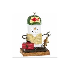 a christmas ornament with a snowman holding a fishing rod on top of a box