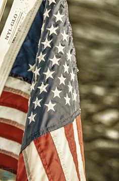 an american flag hanging from the side of a boat