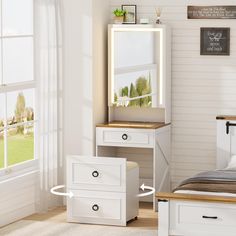 a bedroom with a bed, dresser and mirror next to a large window in the room