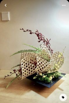 a vase filled with flowers on top of a wooden table