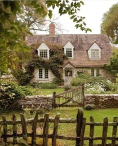 a house with a wooden fence in front of it