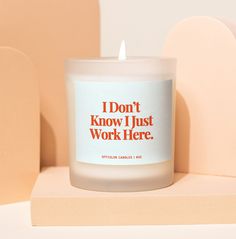 a white candle sitting on top of a wooden block