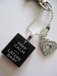 a keychain with a tag attached to it that says keep calm until layers baby