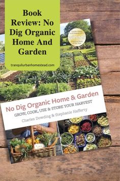 the book review no dig organic home and garden is on top of a wooden table