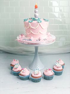 cupcakes and a birthday cake on a table