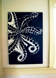 an octopus painting is hanging on the wall