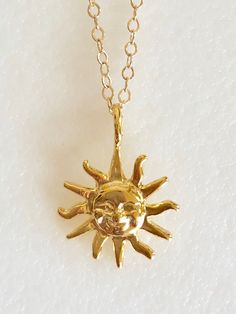 "Darling radiant sun charm necklace in 18k gold vermeil on delicate gold fill chain. Petite smiling face sun charm is 18k gold plate over .925 Sterling silver. Detailed charm measures 15mm with smooth flat back. Total drop with self bail is 3/4\". Necklace is 14k Gold Fill flat cable chain with spring ring clasp. Lovely delicate shiny gold necklace!" Gold Sun-shaped Jewelry For Everyday, Dainty Sun-shaped Necklace For Gift, Dainty Sun Necklace For Gift, Dainty Sun-shaped Gold Jewelry, Gold Dainty Sun-shaped Jewelry, Dainty Gold Sun-shaped Jewelry, Gold Sun-shaped Necklace Gift, Gold Sun-shaped Necklace As A Gift, Gold Sun-shaped Necklace For Gift