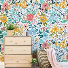 a flowery wallpaper with lots of flowers on it and a plant in the corner