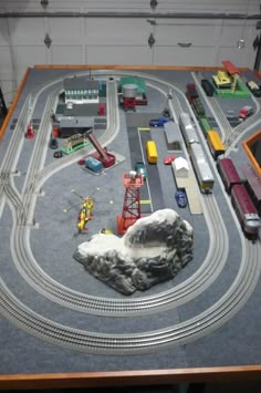 a model train set is displayed on a table