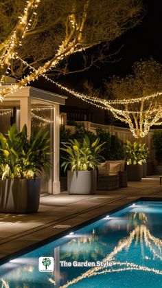 an outdoor pool surrounded by potted plants and lights