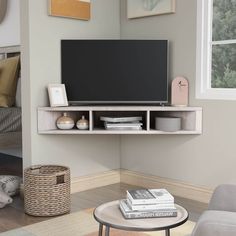 a flat screen tv sitting on top of a wooden shelf