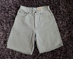 These vintage Eddie Bauer women's denim shorts are a classic addition to your wardrobe. With a high rise waist and a flat front, they are perfect for any casual occasion or adventure. The light mint green color and solid pattern add a pop of color to any outfit, while the 5 pocket design provides ample storage space for your essentials. Made from 100% cotton, these shorts are breathable and easy to care for, making them a great choice for daily wear. The zipper and button closure, along with the belt loops and pockets, provide a classic and timeless look. These shorts are perfect for any woman who wants to add a touch of vintage style to her wardrobe. In great condition! 28" Waist 8" Inseam 11.5" Rise Womens Denim Shorts, Denim Shorts Outfit, Outfits Mit Shorts, Mom Denim, Light Mint Green, Jean Vintage, Womens Denim, Eddie Bauer Women, Denim Shorts Women