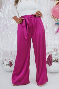 Unveil elegance with our "Best For Last" Satin Pants in Magenta. These luxurious pants exude sophistication with their smooth satin finish and vibrant magenta hue. Perfect for making a bold fashion statement at special events or elevating your everyday style. Date Night outfit inspo Waistband: High rise Fabric: 95% Polyester, 5% Spandex Sleek satin fabrication Adjustable tie belt waistband Wide leg bottom Imported Fit: True to size!- Waist: Elastic/High rise- Leg: Wide leg - Stretch only in wais Elegant Pink Satin Bottoms, Chic Satin Finish Bottoms For Party, Chic Bottoms With Satin Finish For Party, Chic Party Bottoms With Satin Finish, Glamorous Satin Bottoms For Evening, Purple Bottoms For Evening In Spring, Pink Stretch Satin Bottoms, Purple Bottoms For Spring Evening, Elegant Pink Bottoms With Elastic Waistband