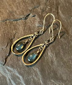 These beautiful, bohemian style dangles feature handcrafted, artisan, gold bronze hoops, with smooth, blue flash labradorite gemstones. The gems are wire wrapped in gold filled wire. The gorgeous ear wires are handcrafted in gold bronze. Total length is approximately 2 inches.  Earrings will arrive in a gift box.  Please ensure that your correct address is listed when you place your order. Terra Glass and Gems is not responsible for lost, stolen, damaged, or misplaced packages. Wire Wrapped Chandelier Earrings For Festivals, Bohemian Wire Wrapped Chandelier Earrings For Festivals, Bohemian Dangle Brass Jewelry, Bohemian Brass Dangle Jewelry, Bohemian Wire Wrapped Earrings For Festivals, Nickel Free Teardrop Earrings For Festival, Handmade Artisan Dangle Chandelier Earrings, Bohemian Chandelier Earrings With Ear Wire For Festivals, Handmade Brass Dangle Chandelier Earrings