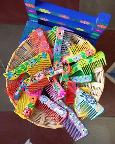 a basket filled with lots of colorful combs