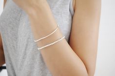 "These Simply yet elegant silver minimal ball bracelet set is prefect for everyday wear. These stunning silver bar bracelet is around 7\" in length. Includes a Bar Bracelet with 3mm beads and a sterling silver bracelet with all 4mm beads. This is the prefect everyday piece to add to any collection. Great wear alone or layered together. Prefect gift for bridesmaids or any special occasion. Price includes two sterling silver bracelets. All Jewelry is personalized and packaged in our small studio ? Minimalist White Sterling Silver Jubilee Bracelet, Minimalist Sterling Silver Pearl Bracelet, Everyday White Sterling Silver Chain Bracelet, Everyday White Sterling Silver Bracelet, Minimalist Silver Pearl Bracelet For Everyday, Dainty White Sterling Silver Bracelet For Everyday, Everyday Delicate Sterling Silver Pearl Bracelet, Minimalist Everyday Silver Pearl Bracelet, Everyday Minimalist Silver Pearl Bracelet