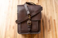 Head out on your next adventure with this Leather Expedition Bag! We love nature, and that's why we created this expeditionary Buffalo leather field bag with all the famous naturalists in mind; Darwin, Muir & Audubon. You can easily carry your field guide books, birding books, maps, binoculars, camera, phone, a snack and more. Whether hiking through the field, in the woods, or up in the mountains, this bag will make you feel even more like you're one of those famous explorers. It's made from Brown Saddle Bag Satchel For Outdoor, Brown Satchel Saddle Bag For Outdoor, Outdoor Leather Shoulder Saddle Bag, Brown Saddle Bag With Adjustable Strap For Outdoor, Leather Saddle Bag With Adjustable Strap For Outdoor, Outdoor Flap Satchel With Adjustable Strap, Rectangular Brown Camera Bag For Outdoor, Brown Rectangular Camera Bag For Outdoor, Waxed Finish Crossbody Satchel For Travel