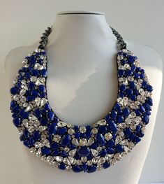 Each piece of our statement necklaces is handmade and one of a kind made in Italy. Our creations is made of high quality materials such as crystals and rhinestones. Each embroidered material is carefully hand sewn. Very glamorous and stylish. Perfect gift to someone you like. Materials Strass stones in Crystal color in different shape and dimension. Enamel stones in Cobalt color.  Black satin fabric backing. Aluminium chain with lobster closure. Measurements Weight approximate 220 grams. Chain lenght 27 cm - 10.62 in Circumference approximate 78 cm - 30.70 in Feel free to contact us if you have any question. Thank you so much for looking at our shop and our articles each of them, single piece. Crystal Necklaces With Sparkling Stones, Crystal Beaded Necklaces With Jewels For Party, Crystal Beaded Necklace With Jewels For Party, Crystal Beaded Necklaces With Rhinestones For Gifts, Handmade Elegant Crystal Rhinestone Necklace, Handmade Crystal Necklaces For Evening, Costume Jewelry Crystal Necklace With Rhinestones, Elegant Handmade Crystal Rhinestone Necklace, Costume Crystal Necklaces With Sparkling Stones