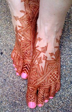 the feet are decorated with hendi designs