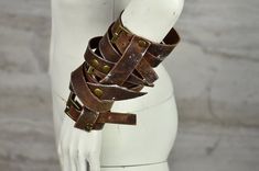 Made from high-quality, durable brown leather (cowhide), these bracers boast a distinctive rugged look with antique brass buckles and rivets that add a touch of historical charm, they look great and are very comfortable.  Their unorthodox design, with the strips overlapping in an irregular pattern adds to their rugged charm, so they might be used either as part of a costume for historical reenactment, live-action role-playing (LARP), or as a stylistic accessory in fashion. Bracers are part of Apocalyptic Warrioress Costume:  https://www.etsy.com/listing/1668418226/full-costume-apocalyptic-warrioress?ref=listings_manager_grid  All of our clothes are handmade, which is why individual pieces may slightly differ from those shown in the photos. If you can't find your size or would like to custo Punk Leather Bracelet For Festivals, Leather Cuff Bracelet With Rivets, Brown Leather Bracelet With Wrist Strap For Festivals, Brown Leather Bracelet With Wrist Strap, Rustic Leather Bracelet For Festivals, Handmade Punk Leather Bracelet, Handmade Leather Punk Bracelet, Costume Armour, Leather Bracers