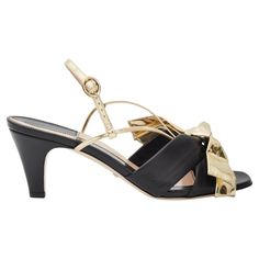 COLOR: Black/gold MATERIAL: Leather SIZE: 36 EU / 5 US HEEL HEIGHT: 50 mm / 2” CONDITION: New COMES WITH: Dust bag and box Made in Italy Bow Sandals, Gucci Black, Gold Material, Heel Height, Dust Bag, Black Leather, Fashion Accessories, In Italy, Pumps