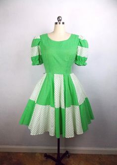 "Vintage 1970's square dance dress in bright green polka dot print. Back zipper closure. In good vintage condition with minor wear. No size tag. Please refer to measurements below when considering fit. Label: Elaine's of California Size: 14* Material: 65% polyester, 35% cotton Length 36\" Bust 36\" Waist 32\" Hips open *Please note that vintage clothing and contemporary sizes can vary greatly. We take measurements of listed garments by laying the garment flat and then doubling the measurement. When considering whether a garment would fit, we suggest taking a similar garment from your own wardrobe and measure it lying flat as we do. Then compare the measurements." Fitted Green Vintage Cotton Dress, Retro Green Square Neck Dress, Retro Green Lined Vintage Dress, Square Dance Dress, Square Dance Dresses, Square Dance, Square Dancing, Green Polka Dot, Dance Dress