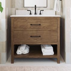 a bathroom with a sink, mirror and towels on the shelf in front of it